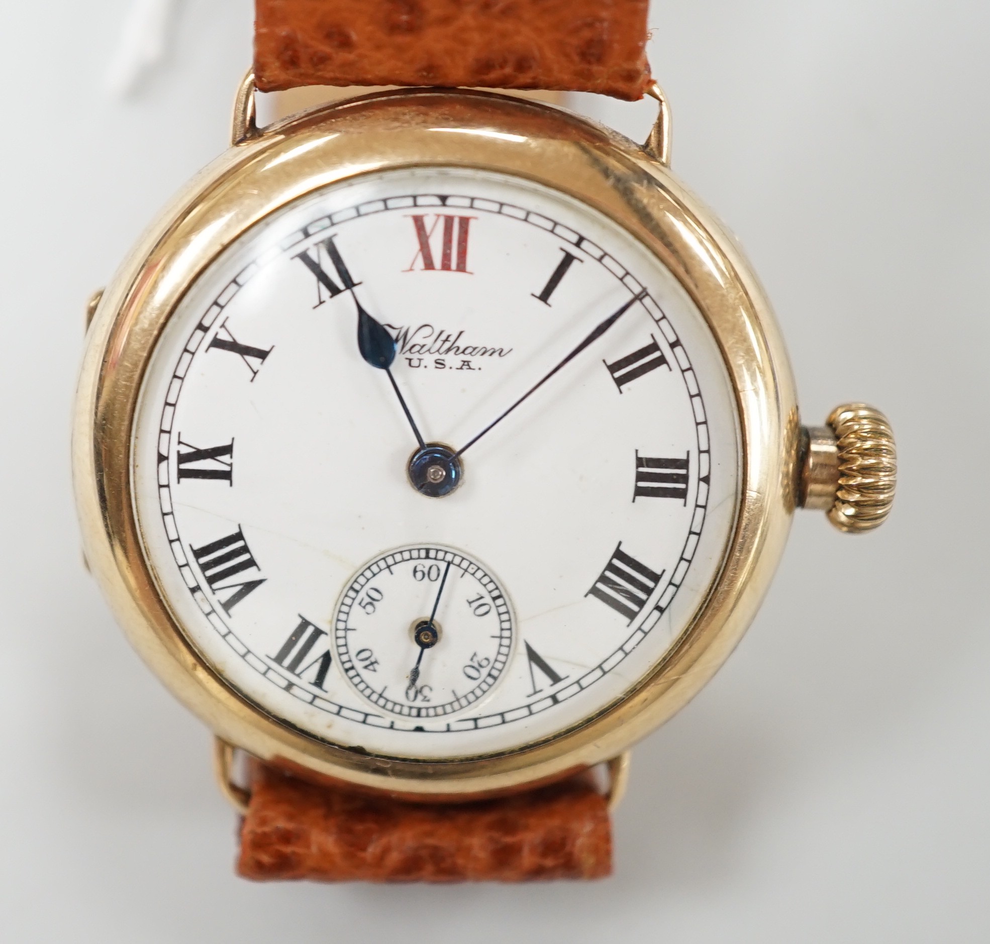 A gentleman's early 20th century 9ct gold Waltham manual wind wrist watch, with Roman dial and subsidiary seconds, on later associated leather strap, case diameter 32mm.